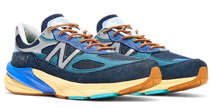 Side view of blue and orange New Balance shoes.
